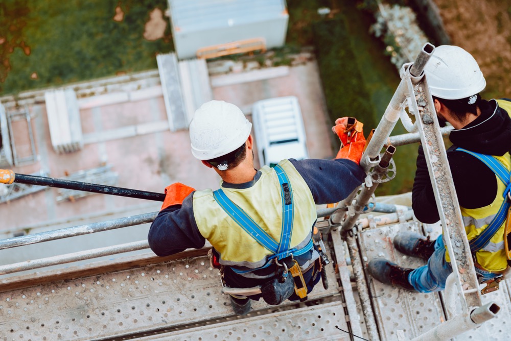 workers trained in OSHA's scaffolding requirements inspect scaffolds on a jobsite