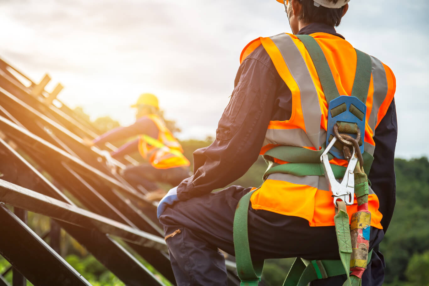 workers wear fall arrest systems per scaffolding safety guidelines