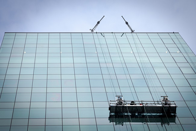 high-rise building window washers on suspended scaffolding
