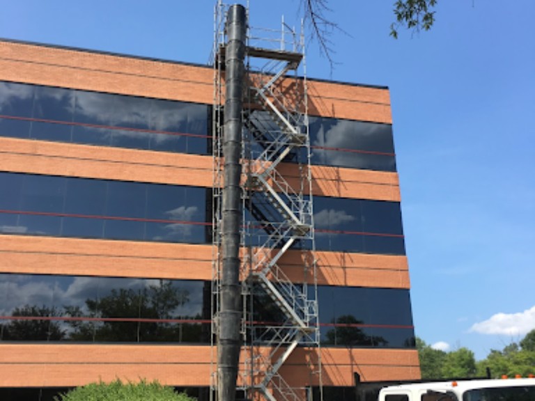 Scaffolding with a construction trash chute