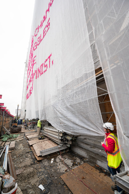 Scaffolding Solutions team making adjustments to the custom netting.