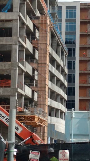 construction trash chute on the side of a parking garage.